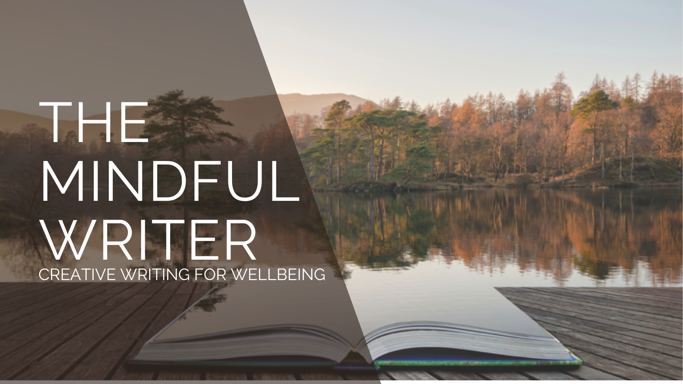A notebook on a wooden jetty merging into a lake surrounded by trees and mountains